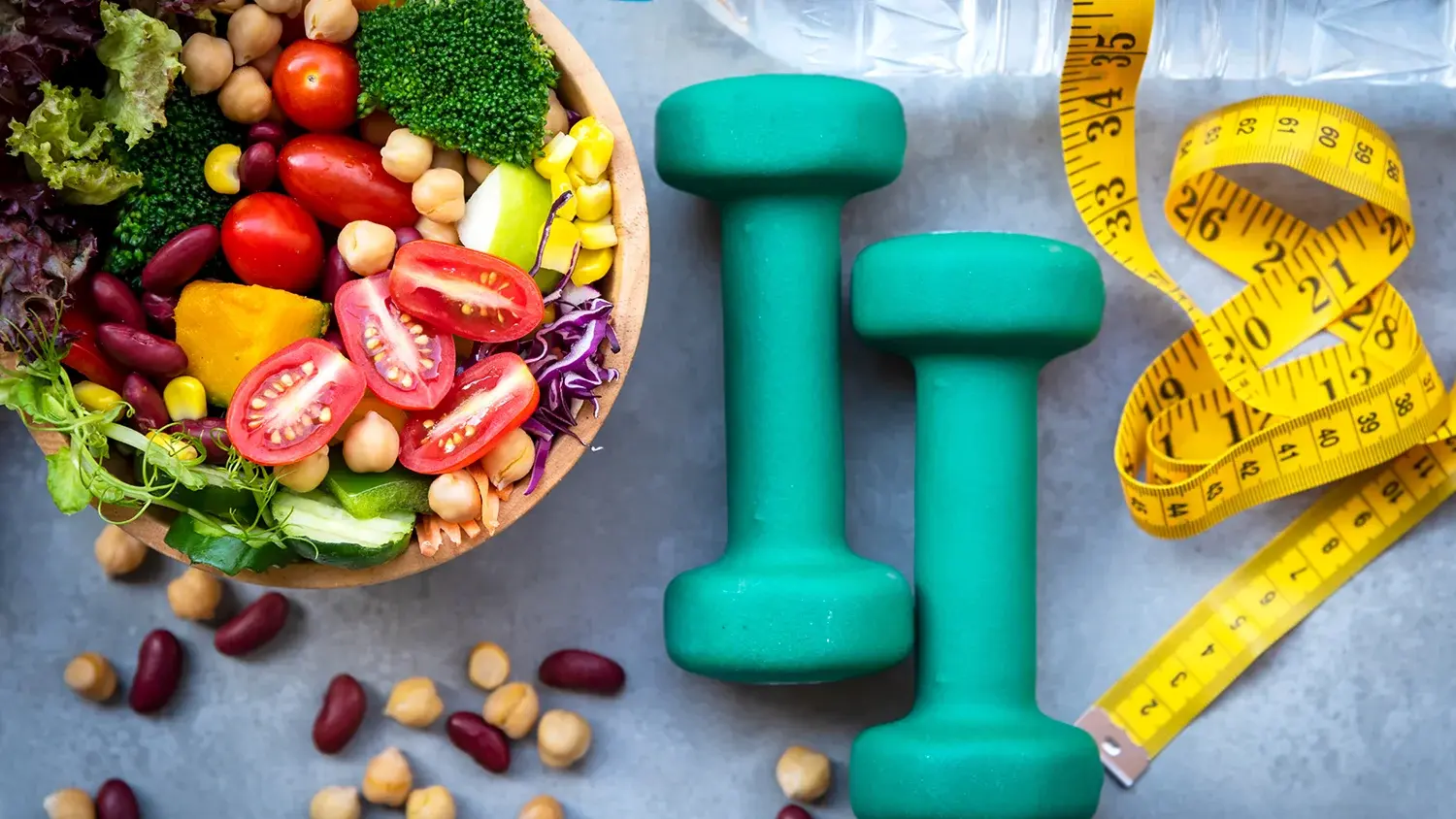 Healthy foods, weights, and fabric tape measure pictured.