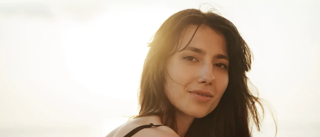 a woman smiles at the camera